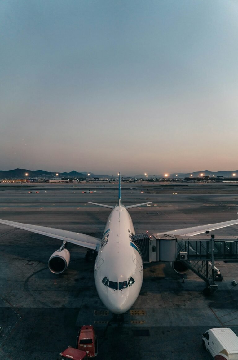 Commercial airplane parked at an airport at night