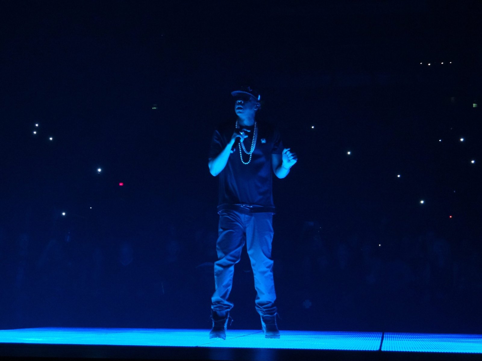 Jay-Z Rehearing Bid Denied in Buzbee Defamation Case 1 Jay-Z performs onstage under blue lighting.